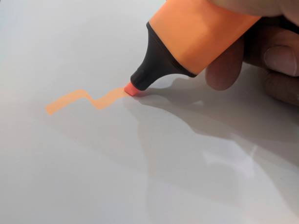 istock The orange pen marker is written on white paper 1338986085