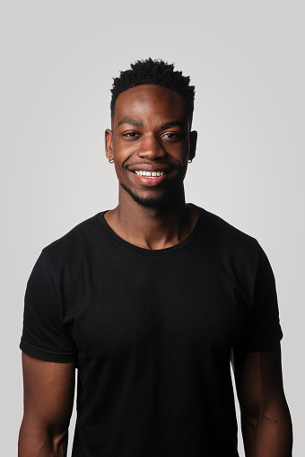 Studio Portrait Of Young African Man In Black T-Shirt On Simple Neutral background. background Colour #d3d2d1