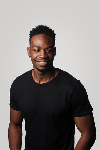 Studio Portrait Of Young African Man In Black T-Shirt On Simple Neutral background. background Colour #d3d2d1