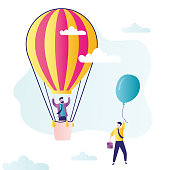 istock Happy businessman overtakes competitor. Entrepreneur in big hot air balloon flies higher 1338987863