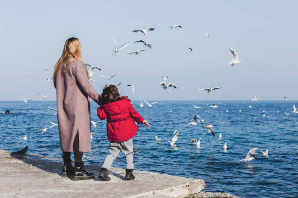istock Mother and son walk to the seaside 1338988100
