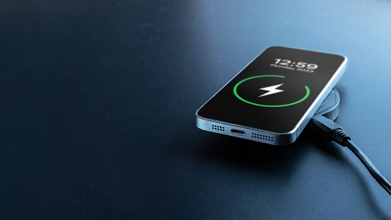 Wireless charger. Mobile cell phone charge battery from wireless smart charger. Modern technology concept