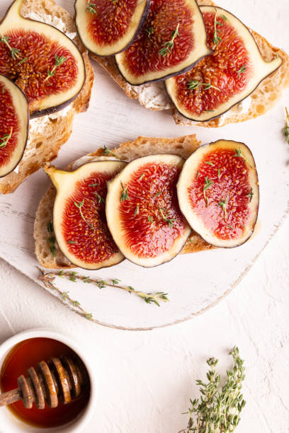 istock Breakfast with sweet bruschettas with figs and honey on a white plate 1338991047