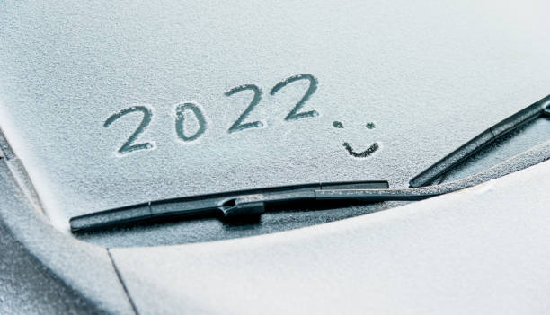 istock New year 2022 and smiling face written on car windshield with snow 1338994292