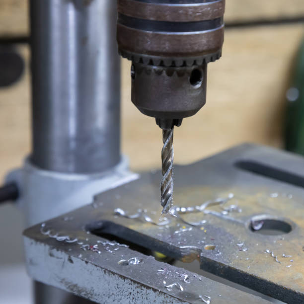 istock drilling machine close up drill in metal shavings 1338994454