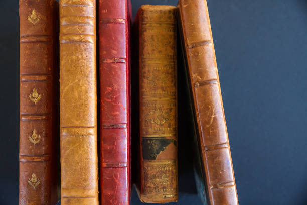 istock Row of old books on dark background 1338994557