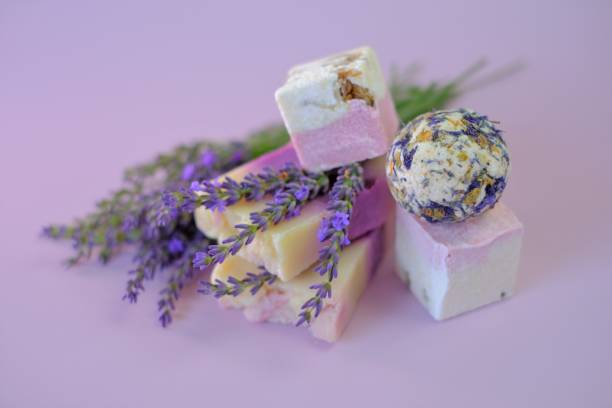istock Lavender Bath Bombs and Soap, lavender on a light purple background.Spa and aromatherapy. Organic herbal cosmetics with lavender extract.Beauty and relaxation concept. 1338995350