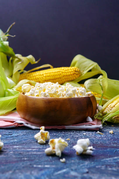 istock Fresh corn and popcorn on cobs on black background. Vertical photo. Copyspace 1338995380