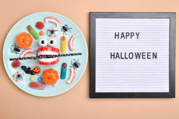 istock A blue plate on the background of various sweets on an orange background with a place for text. 1338996897