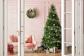 Entrance Of Living Room With Christmas Tree, Ornaments, Gift Boxes And Pink Sofa