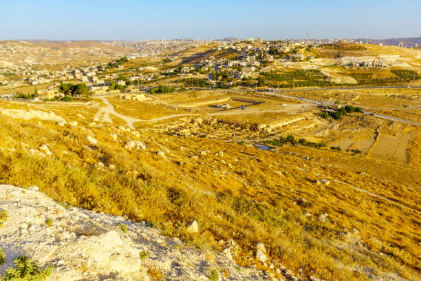Lower Herodium, the Judaean desert and Palestinian villages View towards the lower Herodium, the Judaean desert and Palestinian villages. The West Bank, South of Jerusalem ancient villages stock pictures, royalty-free photos & images