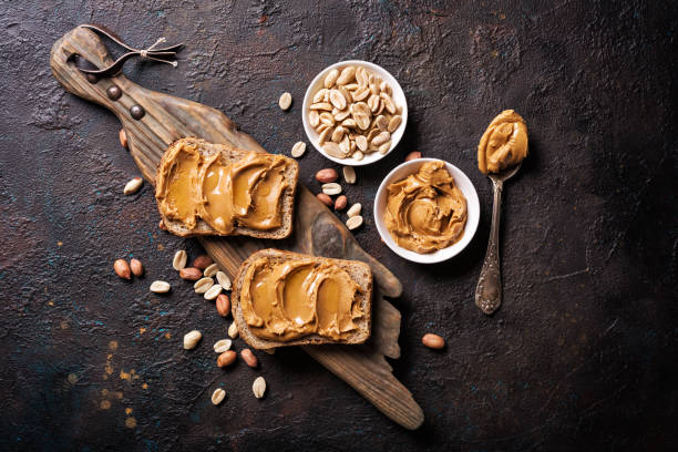 istock Sweet peanut paste or butter with honey on bread 1338998663