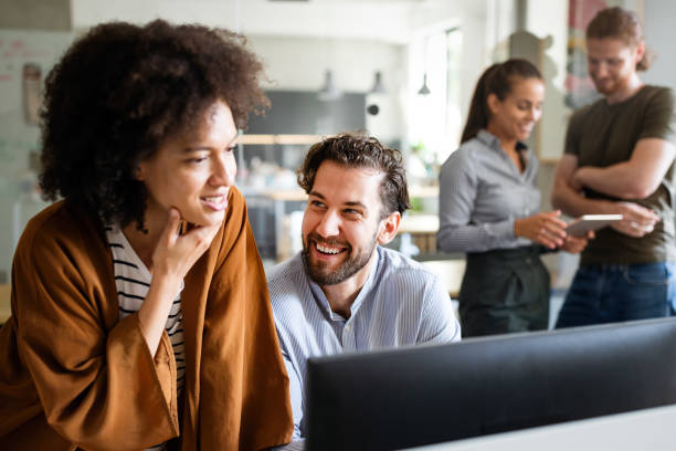 istock Working together on project. Happy young business colleagues working in office 1339002071
