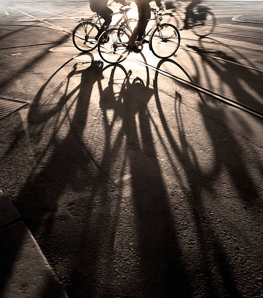 istock Long shadows of bicyclists on the pavement 133900509