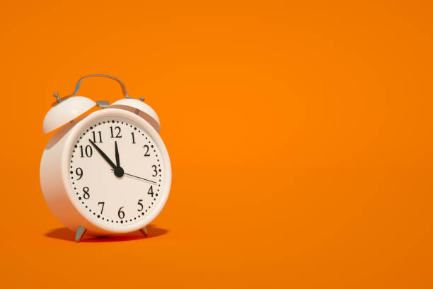istock Alarm Clock on Orange Color Background 1339006731
