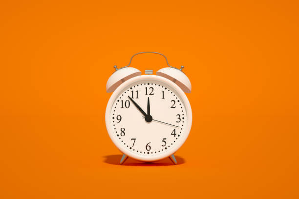 istock Alarm Clock on Orange Color Background 1339006749