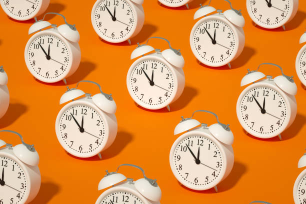 istock Alarm Clock on Orange Color Background 1339006785
