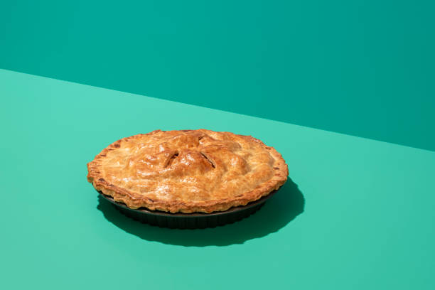 istock Apple pie minimalist on a green table in bright light. Homemade apple tart. 1339008082