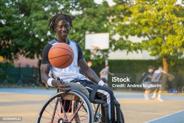 African Man With A Disability Caused By Polio Playing Basketball Champion Athlete Having Disability In A Wheelchair Concept Of Determination And Mental Toughness Stock Photo - Download Image Now