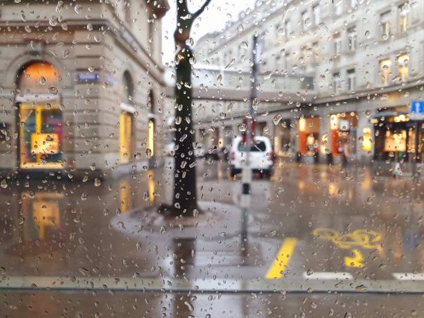 Zurich city captured during a rainy day. The image was made through a window of a tram and shows partially the Bahnhofstrasse.