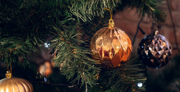 istock Christmas card with tree branch decorated gold balls. Banner with copy space 1339010828