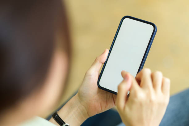 istock Smartphone blank screen mockup using by female with blurred background 1339011866
