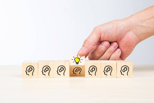 istock Lightbulb icon and brainstorming print screen on wooden block cube. It is creative thinking idea and innovation concept. 1339014114
