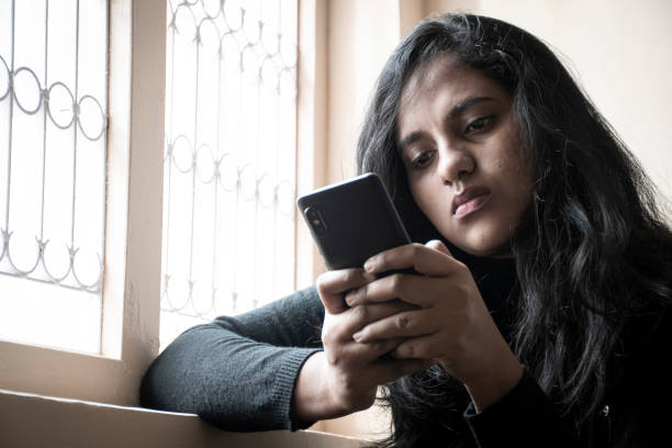 istock woman using mobile in hand with sadness or depression 1339015248