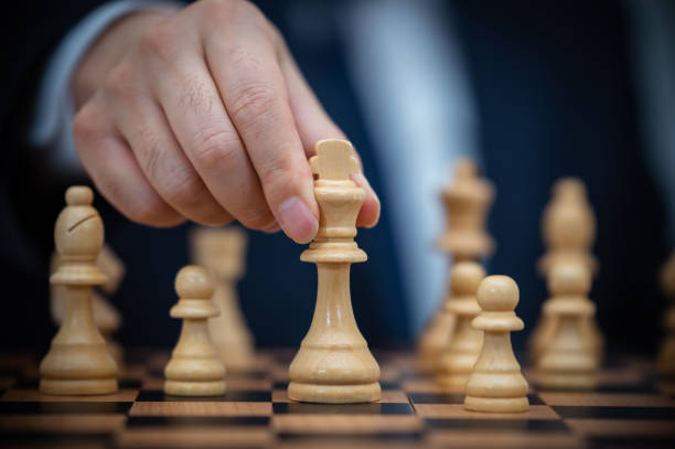 istock A businessman in a suit is holding a chess king. 1339015773
