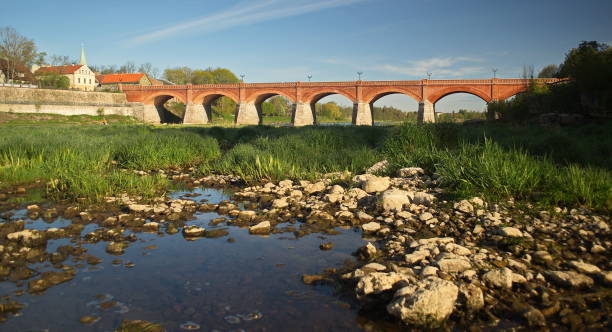 istock Long brick bridge in sunny spring morning, Kuldiga, Latvia 1339015808