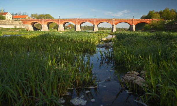 istock Long brick bridge in sunny spring morning, Kuldiga, Latvia 1339015848