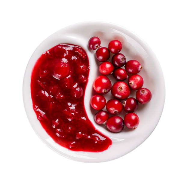 cranberry sauce and fresh cranberry berries on white plate isolated on white background. top view. - jellied cranberries fotos imagens e fotografias de stock