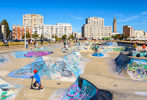 Le Havre, France - June 11, 2021: Young people enjoying scooters in the skatepark with the 