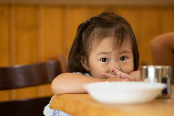 istock Young little girl at table close up 1339020156