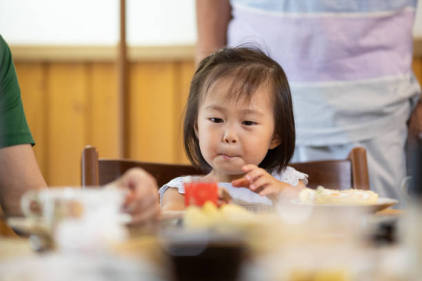 istock Adorable little girl at the dinner table 1339020217
