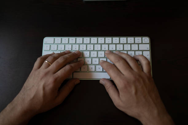 istock Hands typing on computer keyboard. man hands on the keyboard Working at home 1339021504