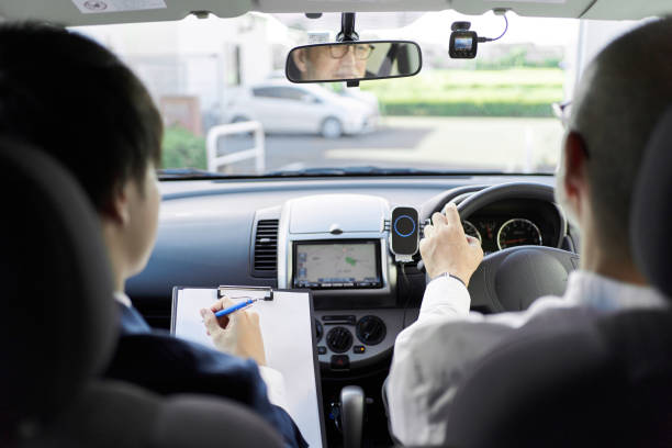 istock Elderly people taking training in driving a car 1339021957