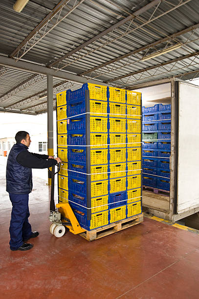 istock Man moving warehouse shipment on metal trolley 133902401