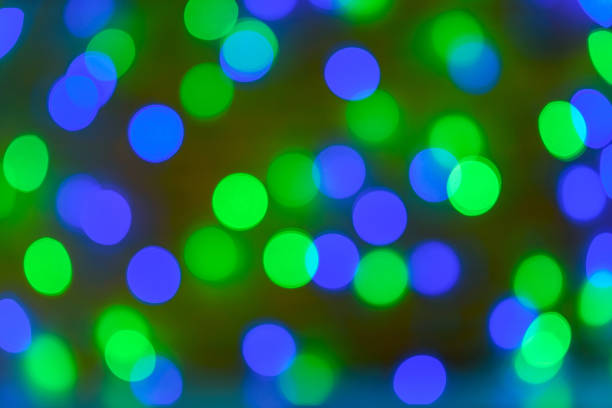 istock Christmas bokeh background, copy space. Defocused new year bokeh lights, free space. Blurred blue and green bokeh. Abstract holiday glitter background 1339024576
