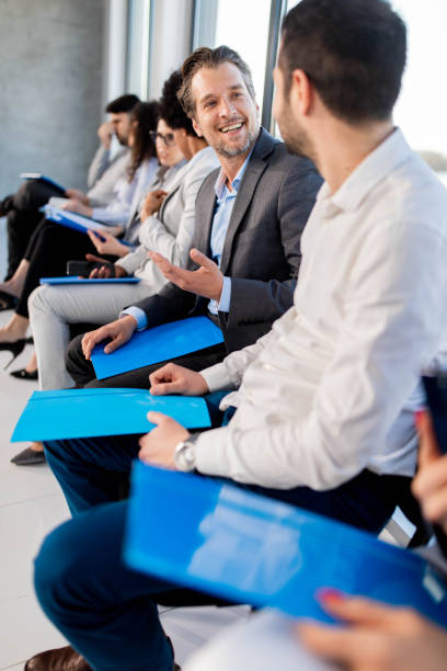 istock Happy business people talking while waiting for the job interview. 1339026557