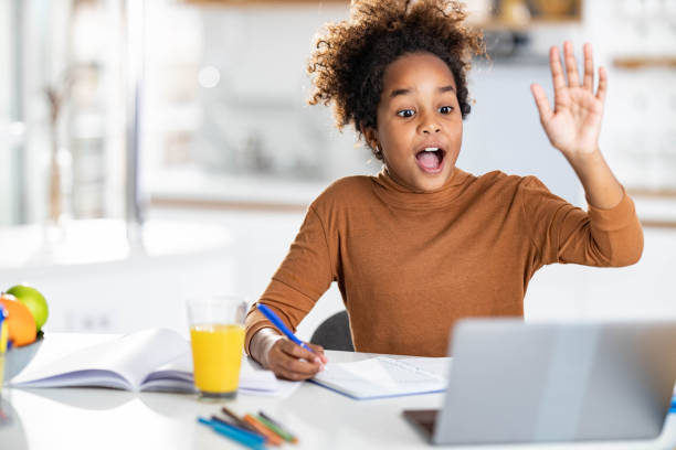 istock Happy black girl waving during online class at home. 1339028134