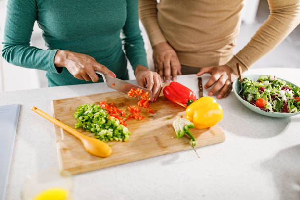 istock Close up of unrecognizable couple cutting bell pepper. 1339028210