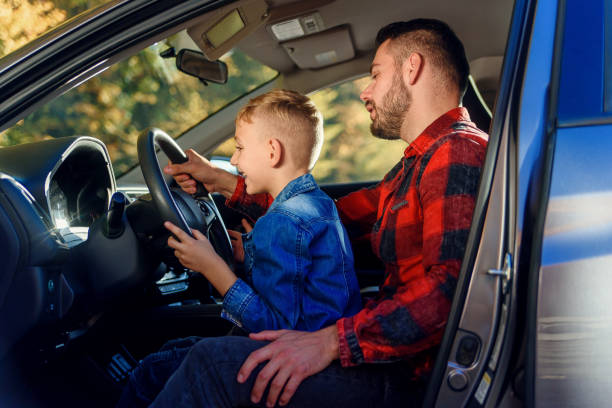 istock handsome father pointing on something while teaching teen son driving car 1339028913