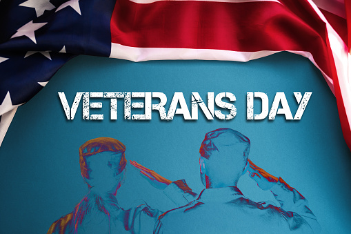 Silhouettes of a two soldiers saluting on a blue background, framed by an American flag. Back view. The concept of the Veterans Day.