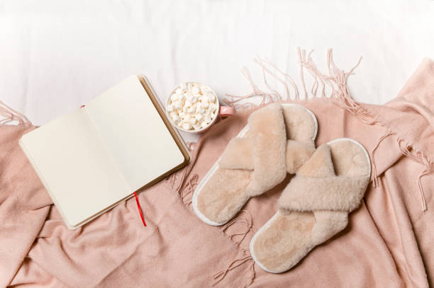 istock a notebook and coffee with a warm blanket on the white bed linen . Breakfast in bed. The concept of Hugge. 1339033127