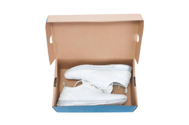 istock Pair of sneakers inside shoe box on white background 1339034363