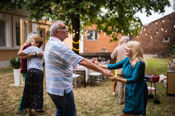 istock Senior friends dancing on party at backyard on summer day 1339035454