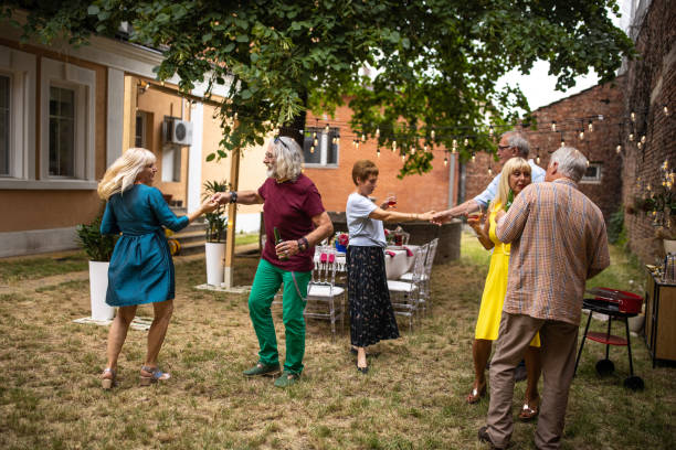 istock Senior friends dancing on party at backyard on summer day 1339035546