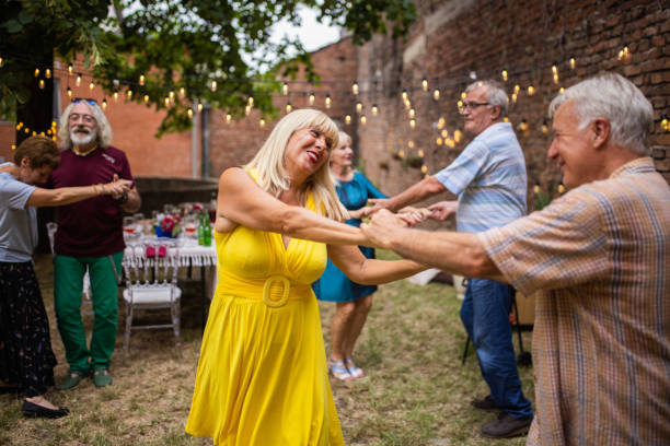 istock Senior couples spending fun time together dancing on party in backyard on summer day 1339038276