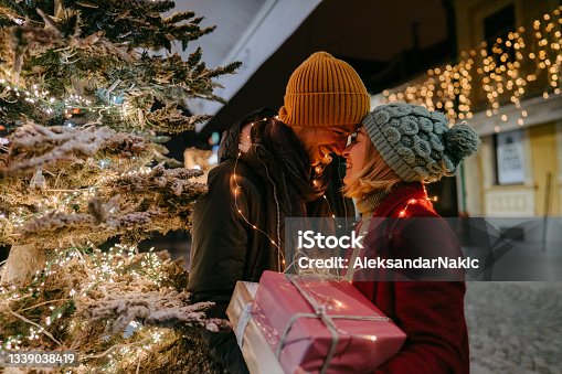 istock Romantic couple with Christmas presents outdoors 1339038419